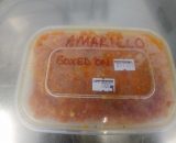 Picture of a frozen tub of Aji Amarillo chillies.