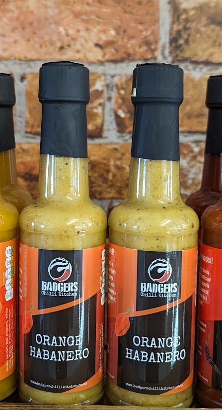 Picture of Badgers Orange Habanero hot sauce on the shelf at the Chilli Ranch.