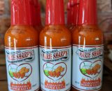 A picture of bottles of Marie Sharp's habanero hot sauce on the shelf at the Chilli Ranch.