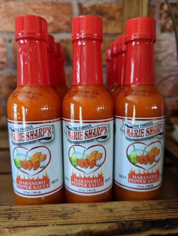 A picture of bottles of Marie Sharp's habanero hot sauce on the shelf at the Chilli Ranch.